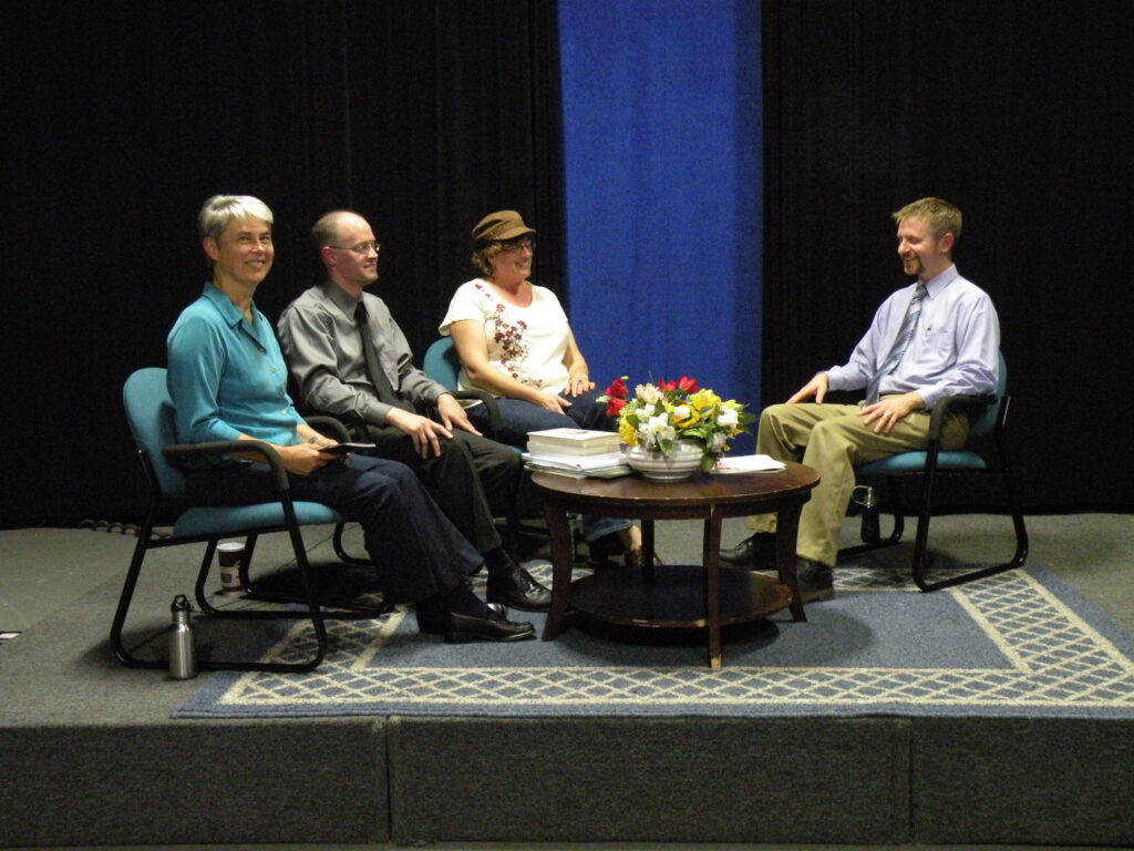 Photo of cable guests and hosts seated around a coffee table.