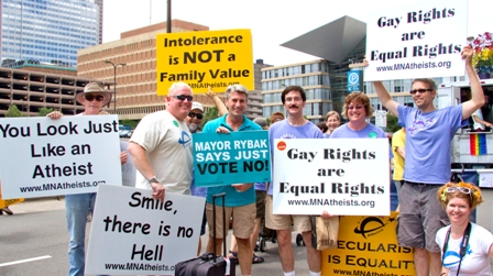 Mayor Rybak posing with MNA members carrying signs like "Intolerance is not a family value" and "Gay rights are human rights."