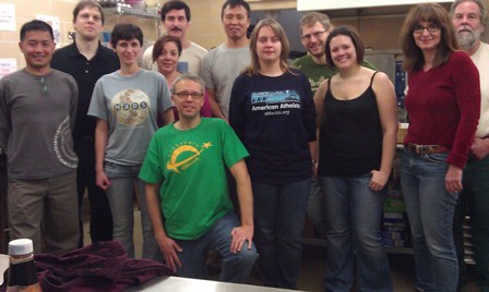 Photo of volunteer team posing in commercial kitchen.