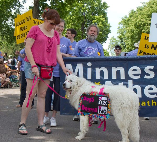 Photo of marchers with dog wearing sign.