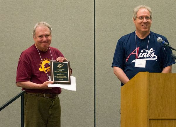 Photo of August Berkshire presenting plaque to George Kane.