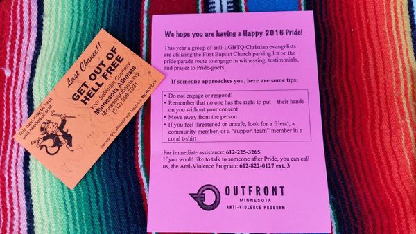 Photo of Get Out of Hell Free card and warning about religious protestors at Pride.