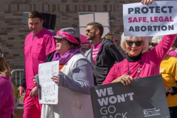 Pro-Choice rally, a person holding a sign that says "Protect safe, legal abortion"